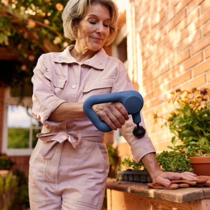 Theragun Relief Handheld Percussion Massage Gun In Use